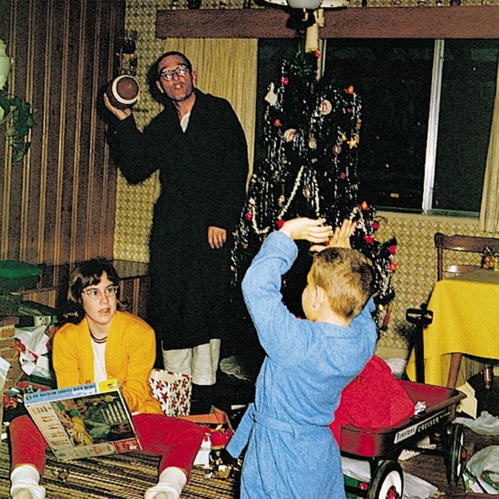 Father and children opening presents on Christmas Day