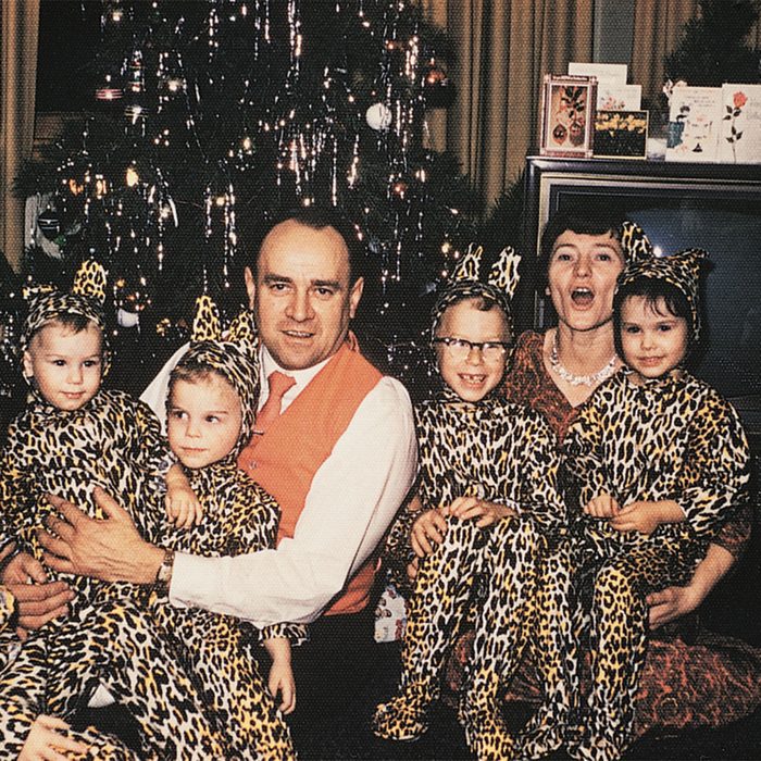 Family posing with matching leopard-print pjs