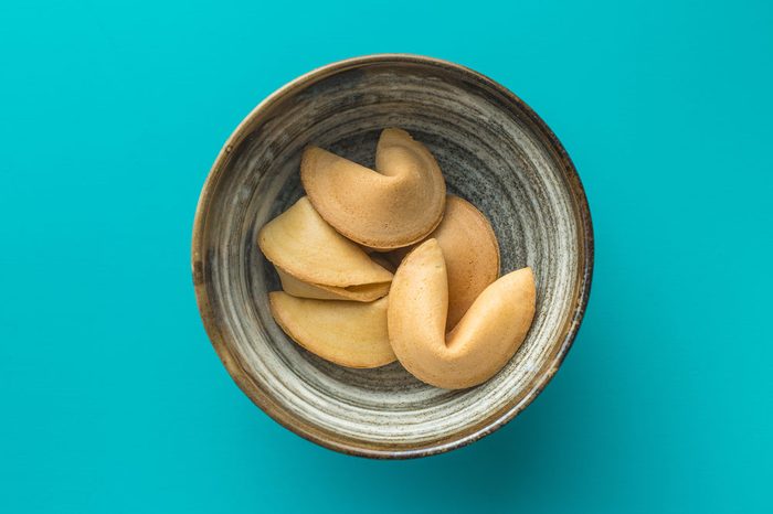 The fortune cookies in bowl on blue background. Top view.