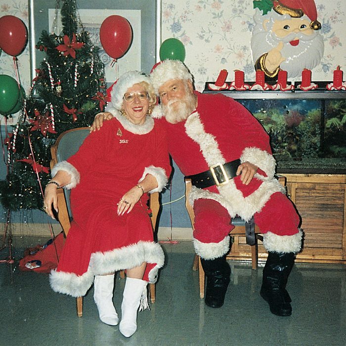 Mr. and Mrs. Claus sitting next to one another