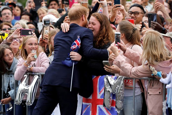 Prince Harry hugging a fan