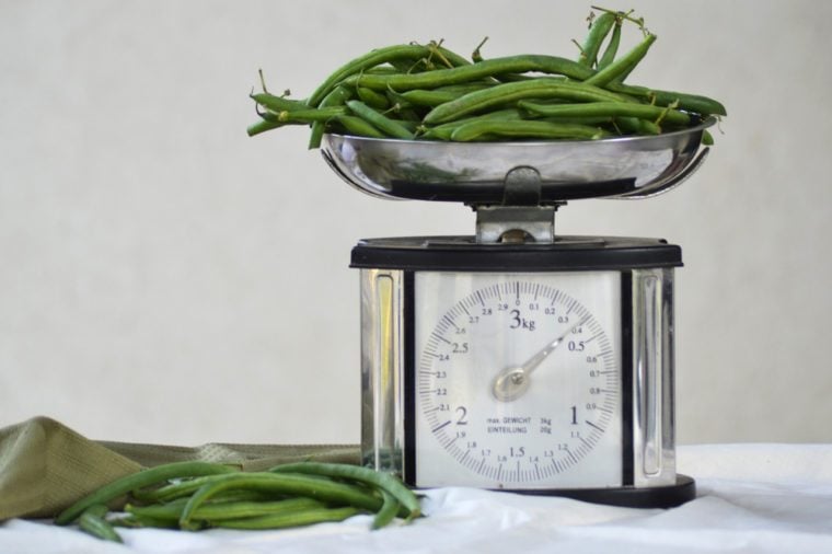 Still life with fresh green beans and balance scale.