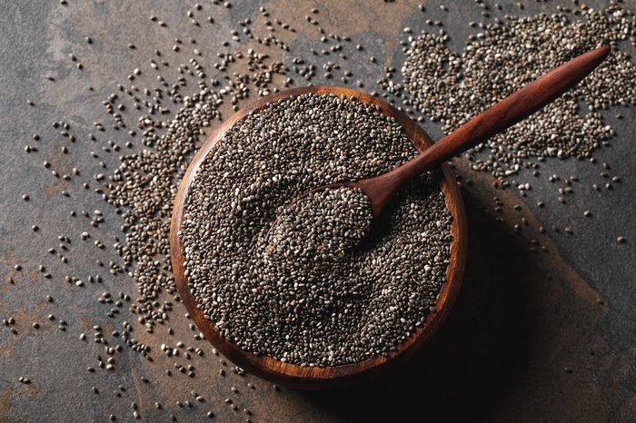 chia seeds in wooden bowl with spoon on table