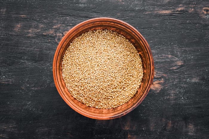 Raw white quinoa. On a black background. Top view. Free copy space.