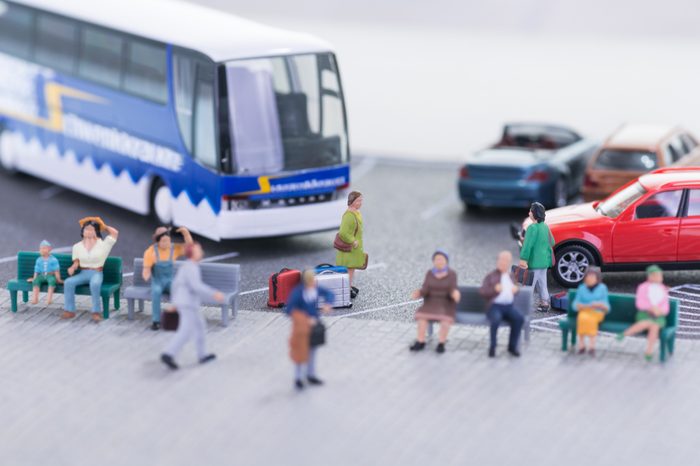 Miniature travellers at a bus station close up