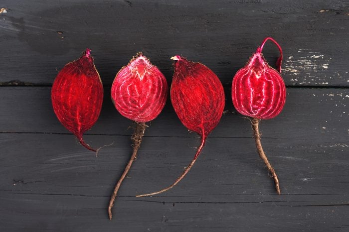 Raw beet on black wooden background.Top view.