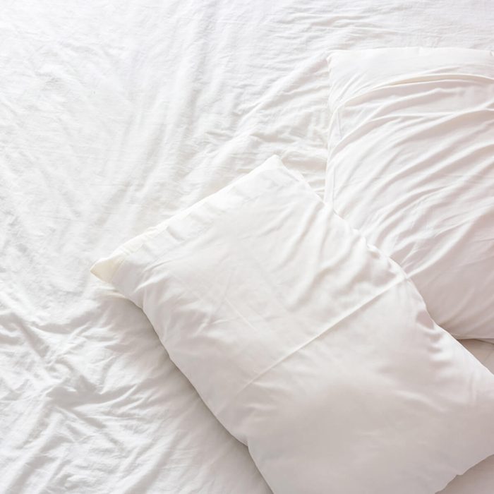shutterstock_402733789 white bed sheets pillows