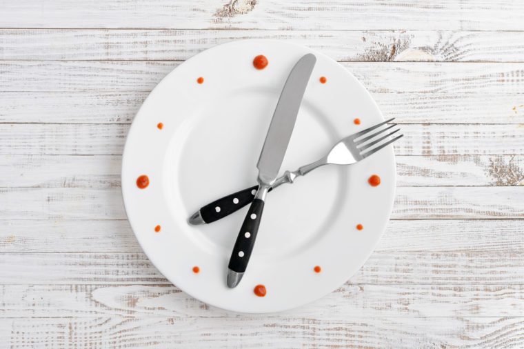 Food clock on white wooden background. Time to eat pasta.