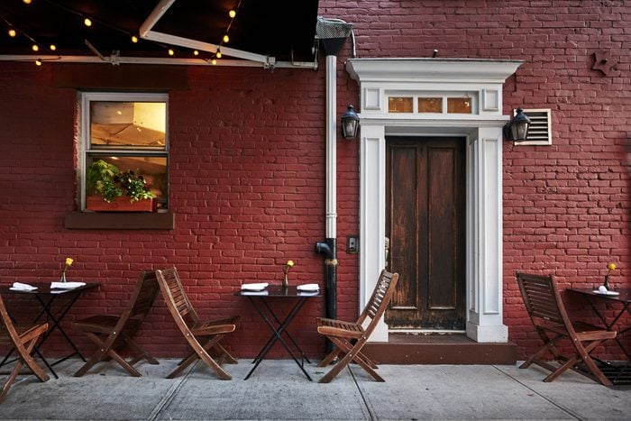 a colorful brick building with tables and chairs in an iconic neighborhood of Brooklyn, New York City