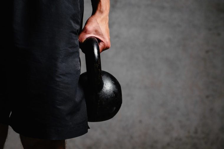 Photo of an athlete arm holding a kettlebell