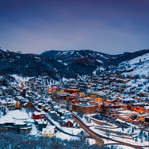 landscape view of park city utah lit up at night among snowy mountains