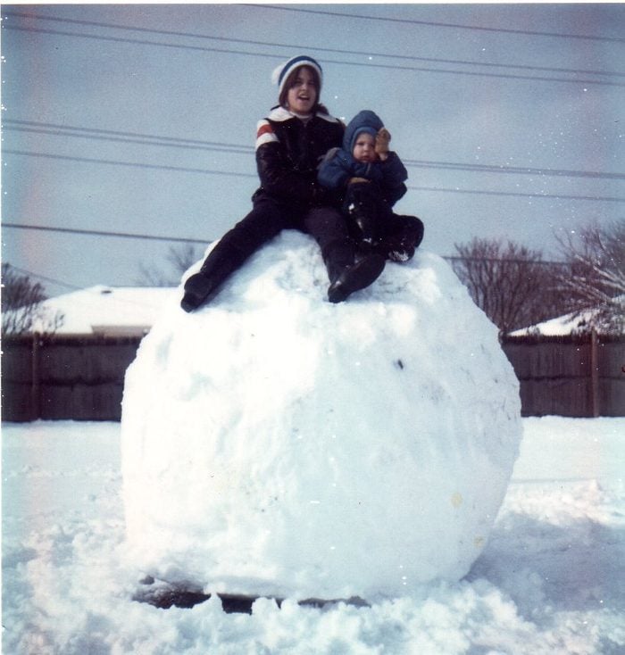 This is my sister Jill and my not too happy cousin Michael sitting on top large;children;front yard;snowball;big;child;snow ball;Caucasian;daytime;oversized;boy;front view;full body;outdoor;portrait;two people;day;2 people;full length;girl;outside;portraiture;color image;day time;vertical;lass;two;colour image;2;lad;kid;boy and girl;people;childhood;female;male;youth