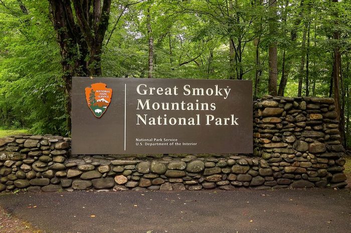 hidden entrance to Great Smoky Mountains National Park entrance sign in forest