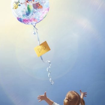 little girl reaching for balloon