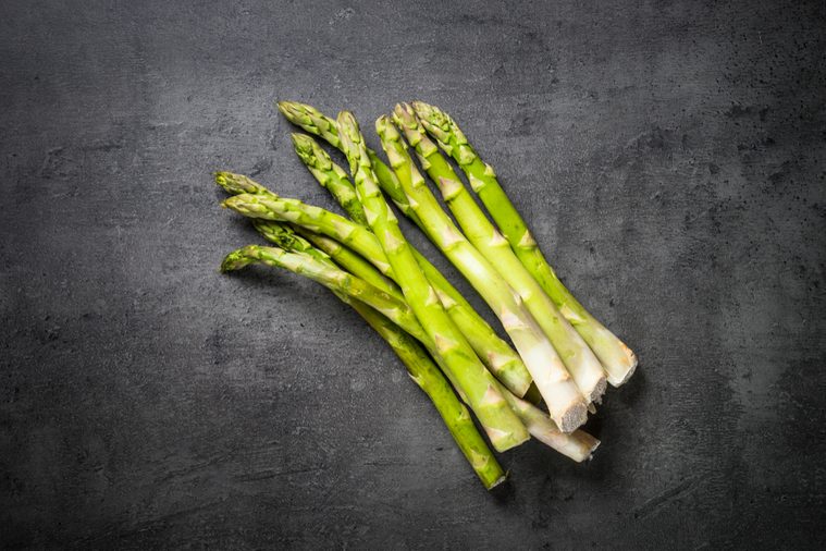 Asparagus. Fresh green asparagus on black slate background. Top view copy space.