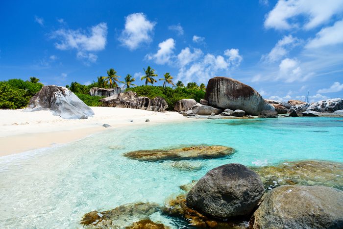 Beautiful tropical beach with white sand, turquoise ocean water and blue sky at Virgin Gorda, British Virgin Islands in Caribbean