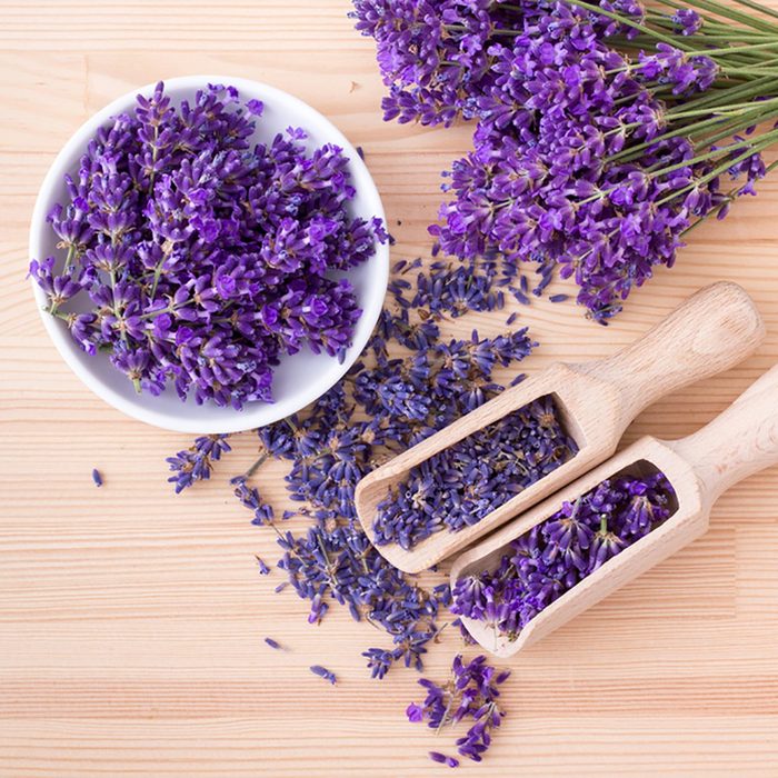 Top view of a bowl and wooden spoons with dried and fresh lavender flowers and a bouquet of lavender on a wooden background ; Shutterstock ID 669397450; Job (TFH, TOH, RD, BNB, CWM, CM): Taste of Home