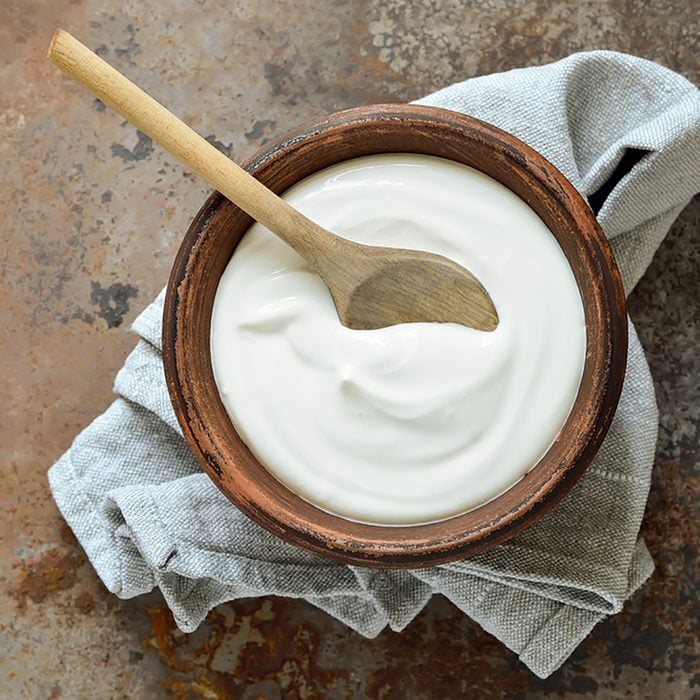 Homemade yogurt or sour cream in a rustic bowl; Shutterstock ID 369768824