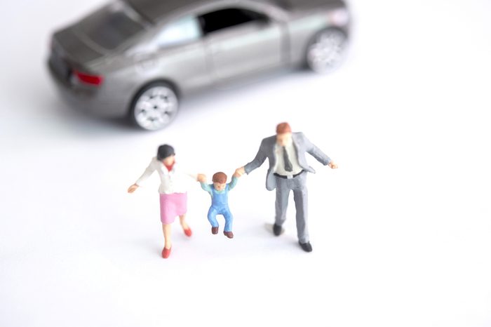 miniature figure of family on white background