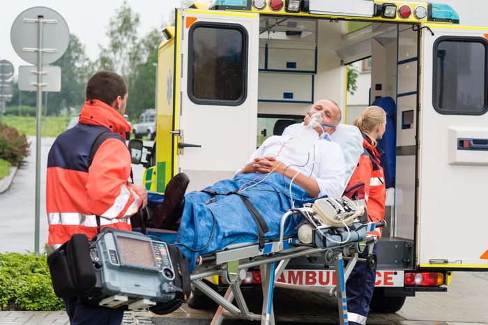 Oxygen mask male patient ambulance stretcher emergency transport hospital