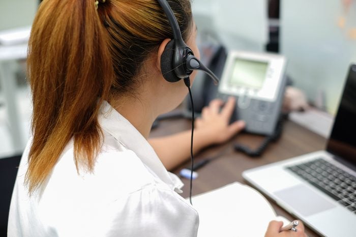 close up focus on headphone of asian call centre response answer or use telephone working in operation room concept.