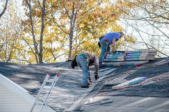 november 1, 2015, Michigan USA; workers repairing a roof by replacing singles and water barrier