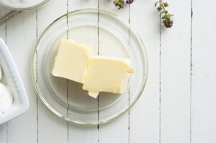 butter on white wooden table background