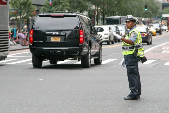 New York, July 27, 2017: African American police woman is directing traffic during the day in Manhattan.