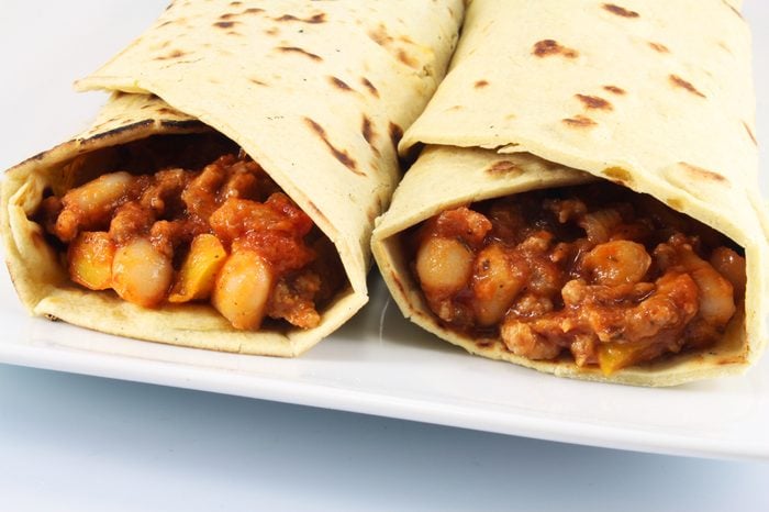 Tortillas with beans, beef and tomatoes close up