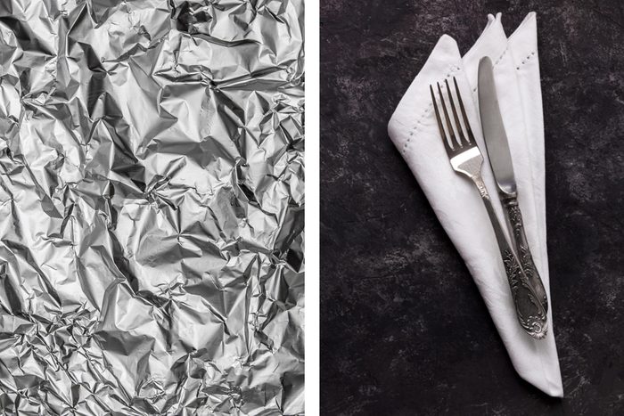Aluminum foil texture next to tarnished silverware