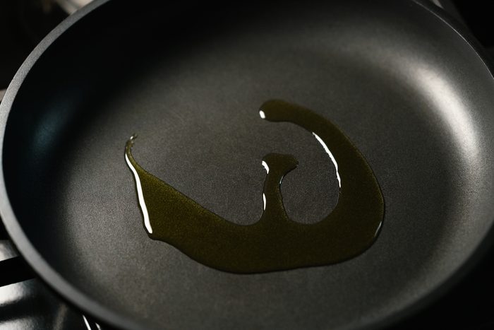closeup olive oil in nonstick frying pan