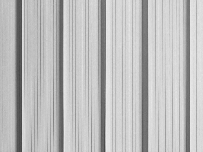 Background vertical office light blinds in backlight. Black and white monochrome image