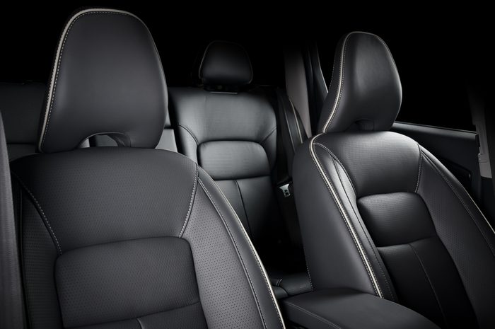 Luxury car inside. Interior of prestige modern car. Comfortable leather seats. Black perforarated leather cockpit.