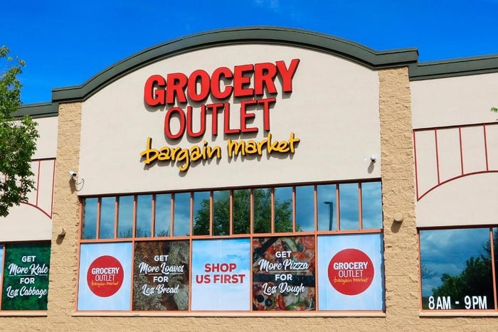 Grocery Outlet Bargain Market Storefront Showing Company Logo, Store Hours and Weekly Advertisements on the windows