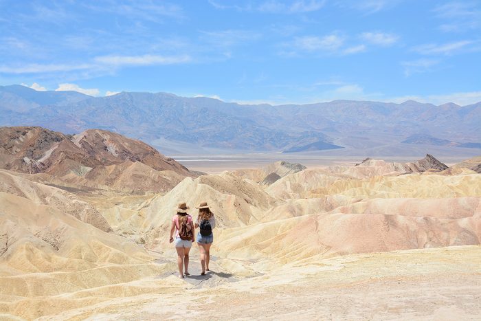 Friends hiking in the mountains on vacation trip. Death Valley National Park landscape , eastern California and Nevada, USA.