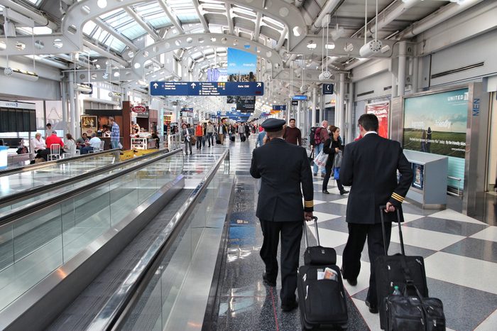 CHICAGO, USA - APRIL 1, 2014: Pilots walk to gate at Chicago O'Hare International Airport in USA. It was the 5th busiest airport in the world with 66,883,271 passengers in 2013.