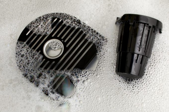 Cleaning Keurig Coffee Maker Parts with soap in sink