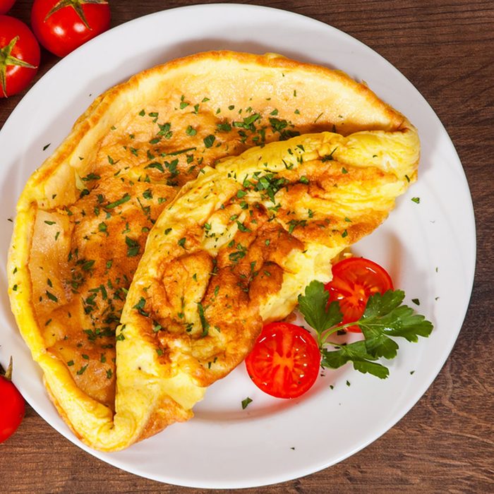 omelet in a plate on wooden table
