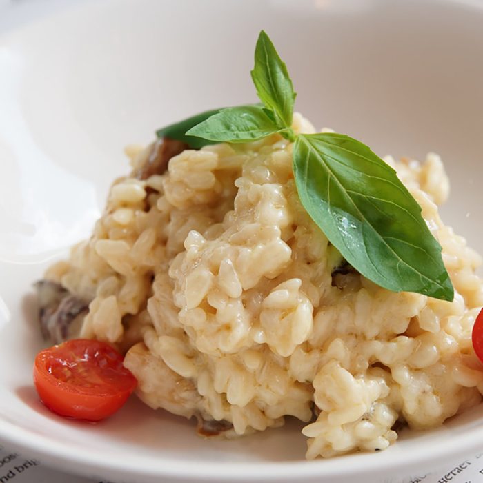 Creamy risotto with basil, cherry tomatoes and mushrooms