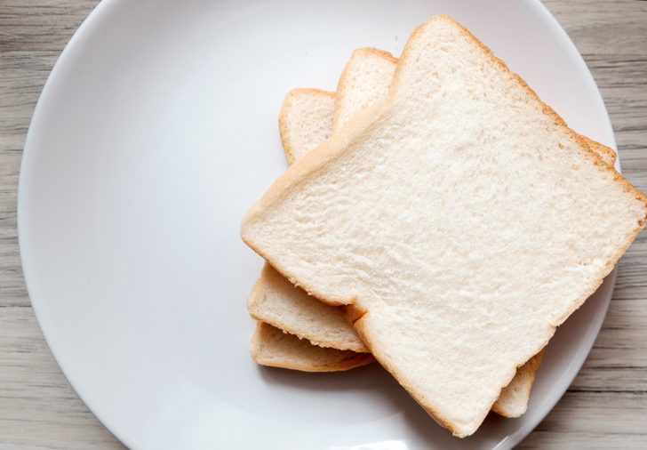 Toasted 3 slice of bread on white plate , Normal angel on the table , Selective focus