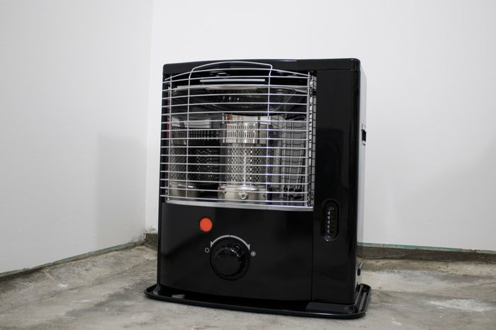 Black kerosene heater in a white background composition