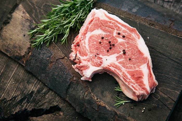 Meat. Raw rump steak on wood with herbs