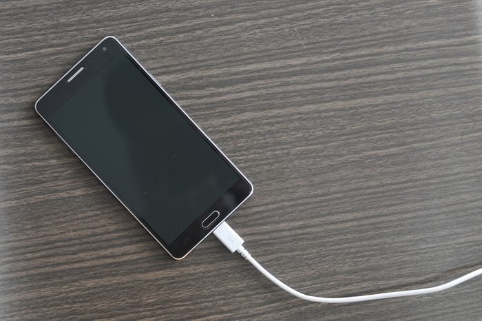 Smart phone Charging On Wood background