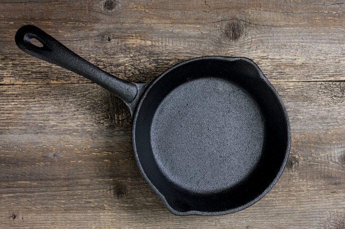 empty cast-iron pan on the old wooden background