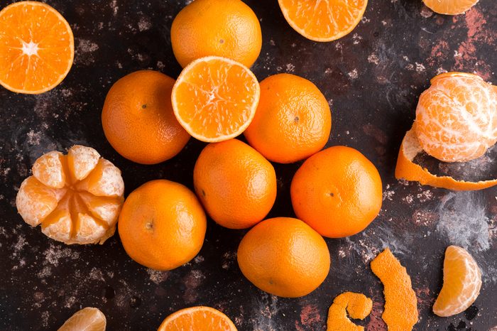 Fresh colorful Mandarins oranges on the Dark Background. Citrus background