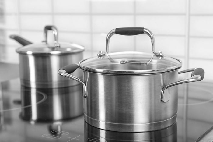 Metal saucepan on electric stove in kitchen
