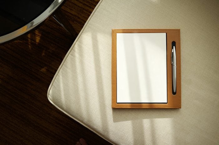 Notebook / notepad with pen on a cozy sofa