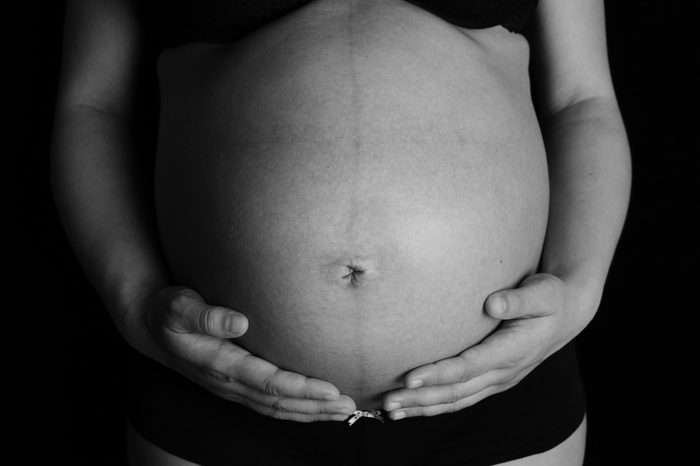 A pregnant woman in black and white