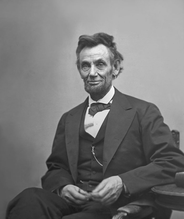 VARIOUS U.S. President Abraham Lincoln, Portrait, Seated next to Table Holding Spectacles and Pencil, Washington DC, USA, by Alexander Gardner, February 1865