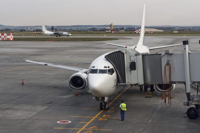 Passenger plane in the airport . Aircraft maintenance.